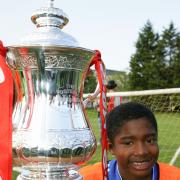 One for the future: Former Met Police youngster Tane Caubo pictured with the FA Cup as a nine-year-old