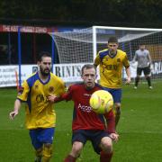 Hard graft: Josh Casey holds off an AFC Sudbury defender at the Beveree on Saturday