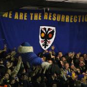 Up for it: Spirits were high at Kingsmeadow in January as AFC Wimbledon hosted Liverpool in the FA Cup third round
