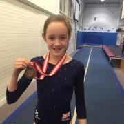 Bronzed: Richmond Gymnastics Association’s Georgie Forbes, 11, and her medal