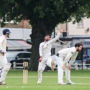 Spin king: Don Manuwelge, centre, claimed five wickets against Ealing on Saturday