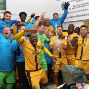 Sutton United players and staff celebrate beating Cheltenham Town in the FA Cup Second Round at Gander Green Lane last Saturday. Photo: Paul Loughlin