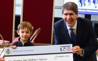 Theo, in Year 1, collecting the cheque with Headmaster Mr Brierly