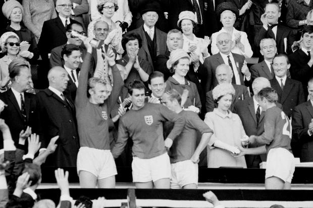 England Captain Bobby Moore holds aloft the Jules Rimet Trophy, followed by hat-trick hero Geoff Hurst, Bobby Charlton and Roger Hunt (PA Photo/Empics)