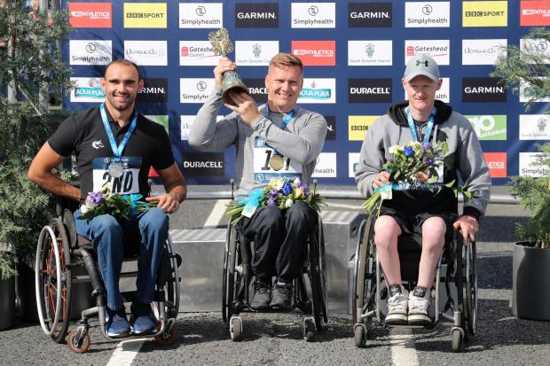 David Weir (centre) celebrates winning the Wheelchair Elite race during the 2018 Simply Health Great North Run. Photo: Richard Sellers / PA